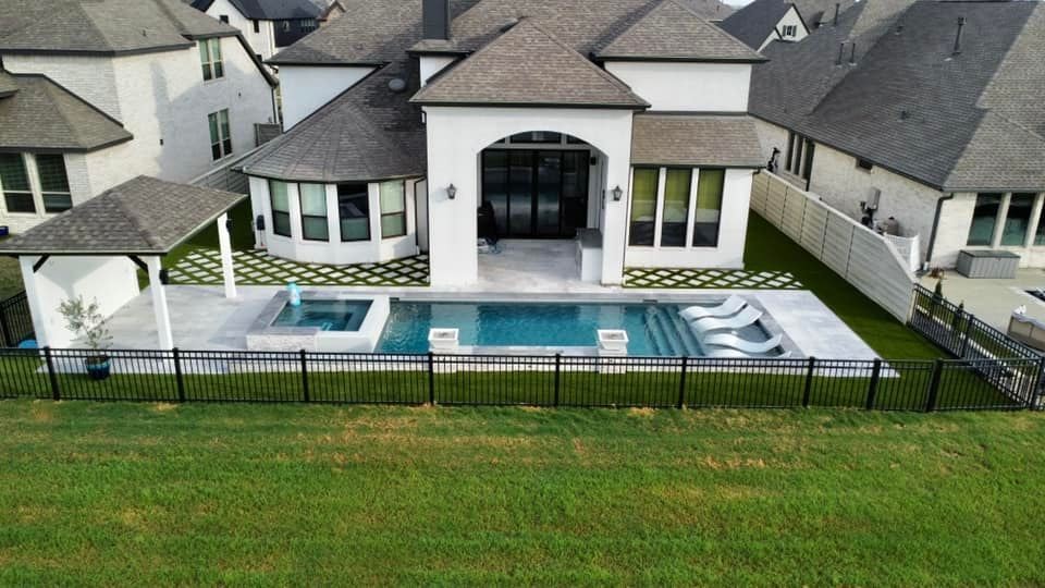 Modern geometric pool with tanning ledge and travertine decking