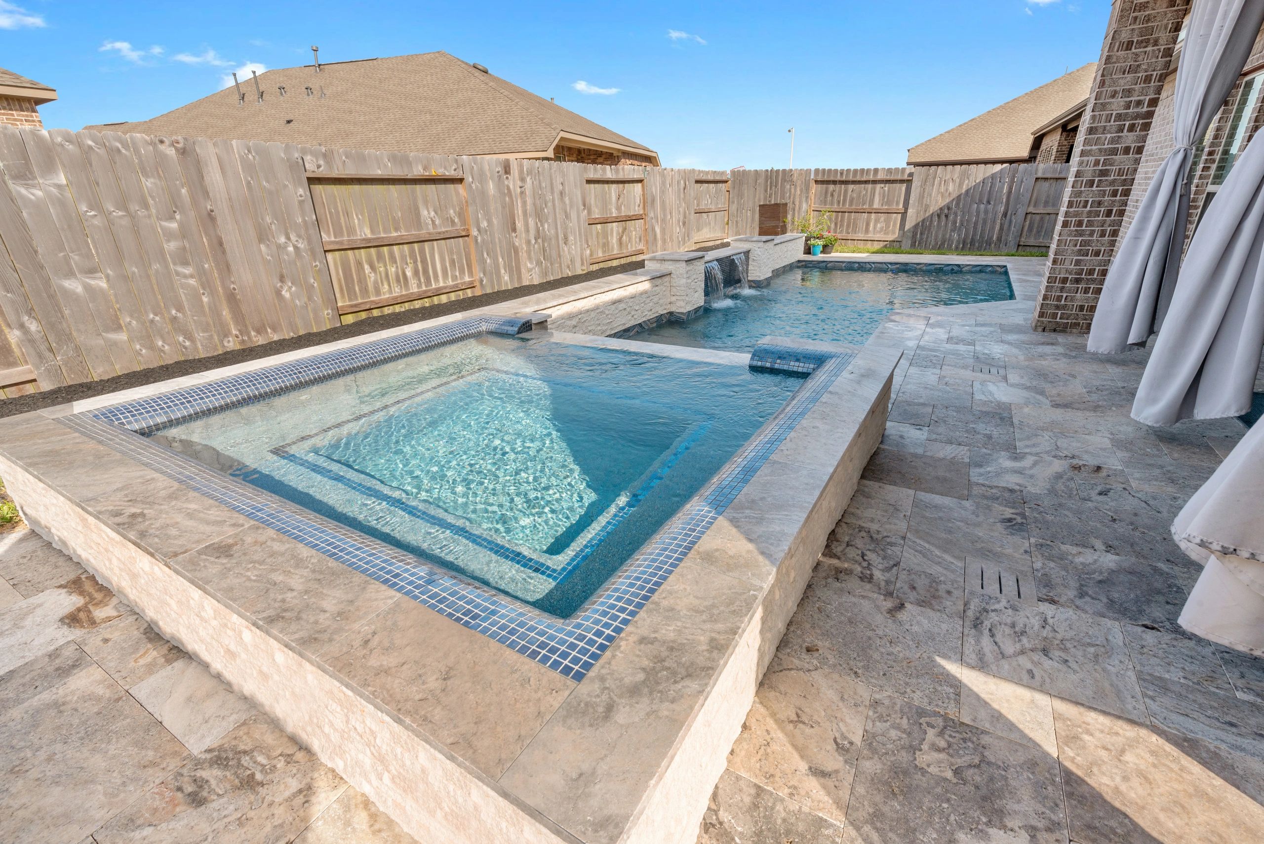 Pool builder reviewing finished custom pool construction details